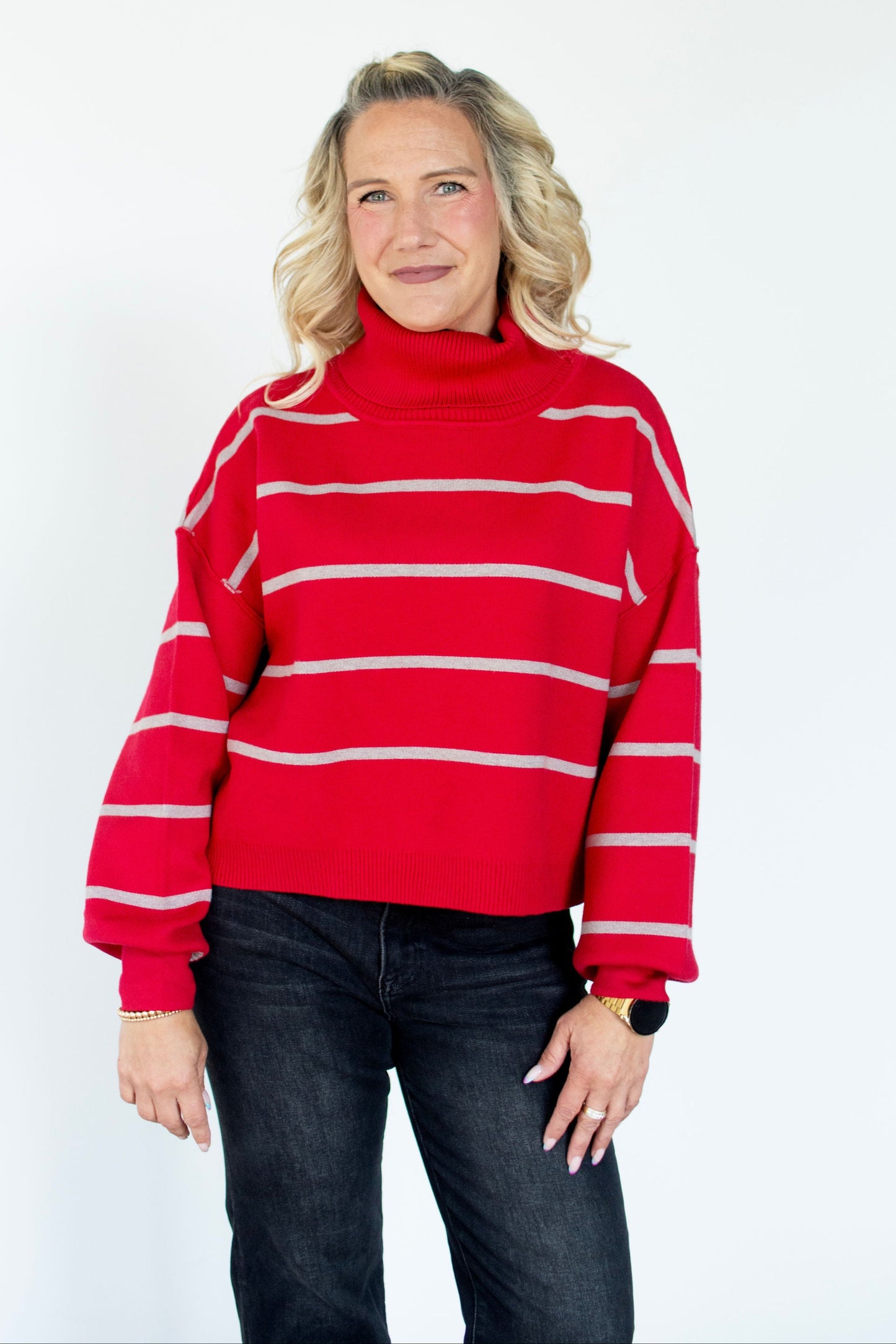Woman wearing a red and white striped sweater against a white background