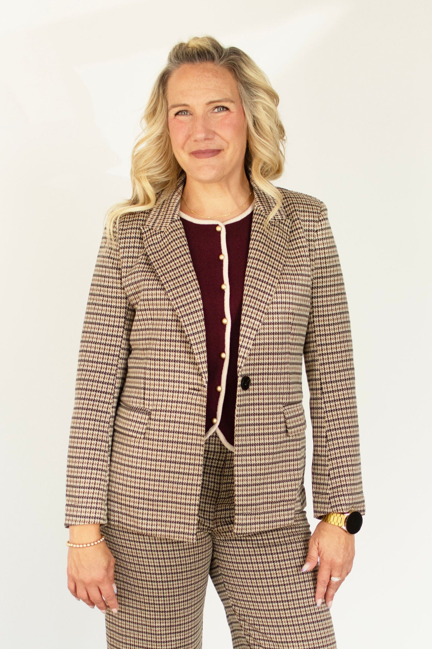 Woman wearing a plaid suit with a white background